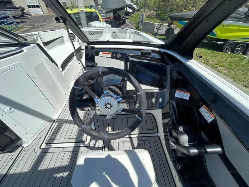 Slide: The Image of 2025 Yamaha Boats 222S cockpit with steering wheel and control panel, showcasing modern design. - 9