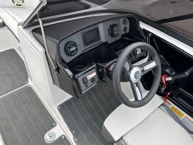 Slide: The Image of 2022 Yamaha Boats AR190 cockpit with steering wheel and dashboard controls. - 13
