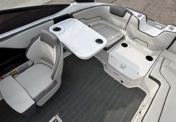 Slide: The Image of 2022 Yamaha Boats AR190 interior with seating and table, featuring modern design and cup holders. - 21
