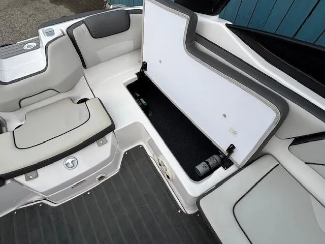 Slide: The Image of 2022 Yamaha AR190 boat interior with open storage compartment and cushioned seating. - 24