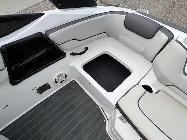 Slide: The Image of 2022 Yamaha Boats AR190 interior with cushioned seating and storage compartments. - 25