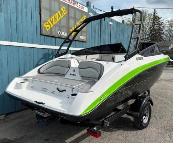 Slide: The Image of 2022 Yamaha AR190 boat with sleek design, green accents, and trailer, parked outdoors. - 3