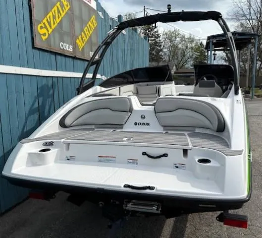 Slide: The Image of 2022 Yamaha AR190 boat, rear view, parked near Sizzle Marine sign. - 4