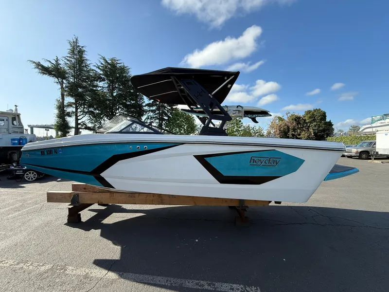 Slide: The Image of 2023 Heyday WT-2DC boat with sleek design, parked outdoors under a clear sky. - 4