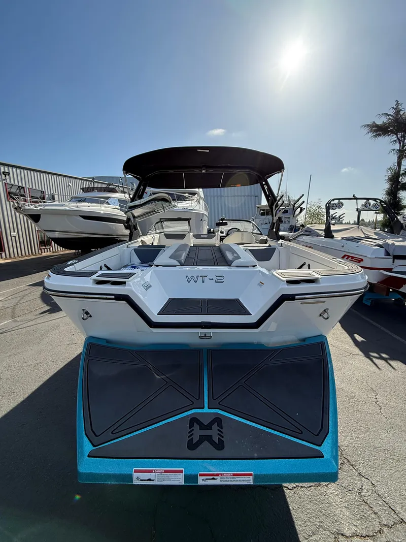 Slide: The Image of 2023 Heyday WT-2DC boat, sleek design, parked outdoors under clear sky. - 5