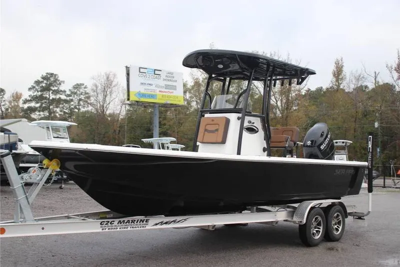 Slide: The Image of 2025 Sea Pro 230 Bay boat on trailer, displayed outdoors at a dealership. - 0