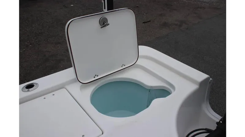 Slide: The Image of 2025 Sea Pro 230 Bay boat with open storage compartment on deck. - 12