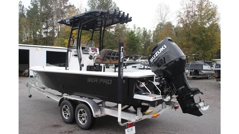 Slide: The Image of 2025 Sea Pro 230 Bay boat on trailer with Suzuki outboard motor. - 2