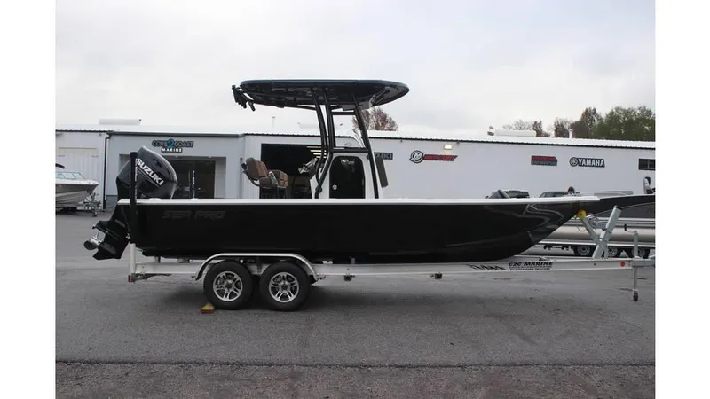 Slide: The Image of 2025 Sea Pro 230 Bay boat on trailer, parked outside dealership. - 3