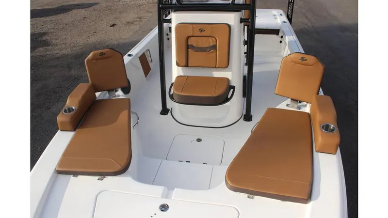 Slide: The Image of 2025 Sea Pro 230 Bay boat interior with tan cushioned seating and cup holders. - 4