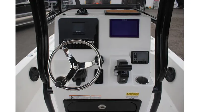 Slide: The Image of 2025 Sea Pro 230 Bay boat dashboard with steering wheel and electronic controls. - 7