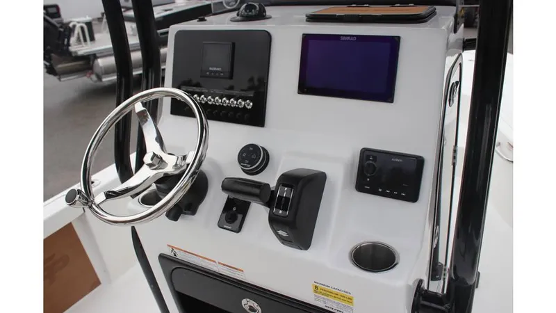 Slide: The Image of 2025 Sea Pro 230 Bay boat dashboard with steering wheel and electronic controls. - 8