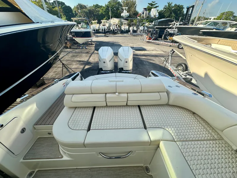 Slide: The Image of 2025 Chris-Craft Launch GT 31 boat with luxurious seating, docked at a marina. - 12