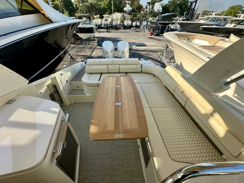 Slide: The Image of 2025 Chris-Craft Launch GT 31 interior with elegant seating and wooden table. - 13