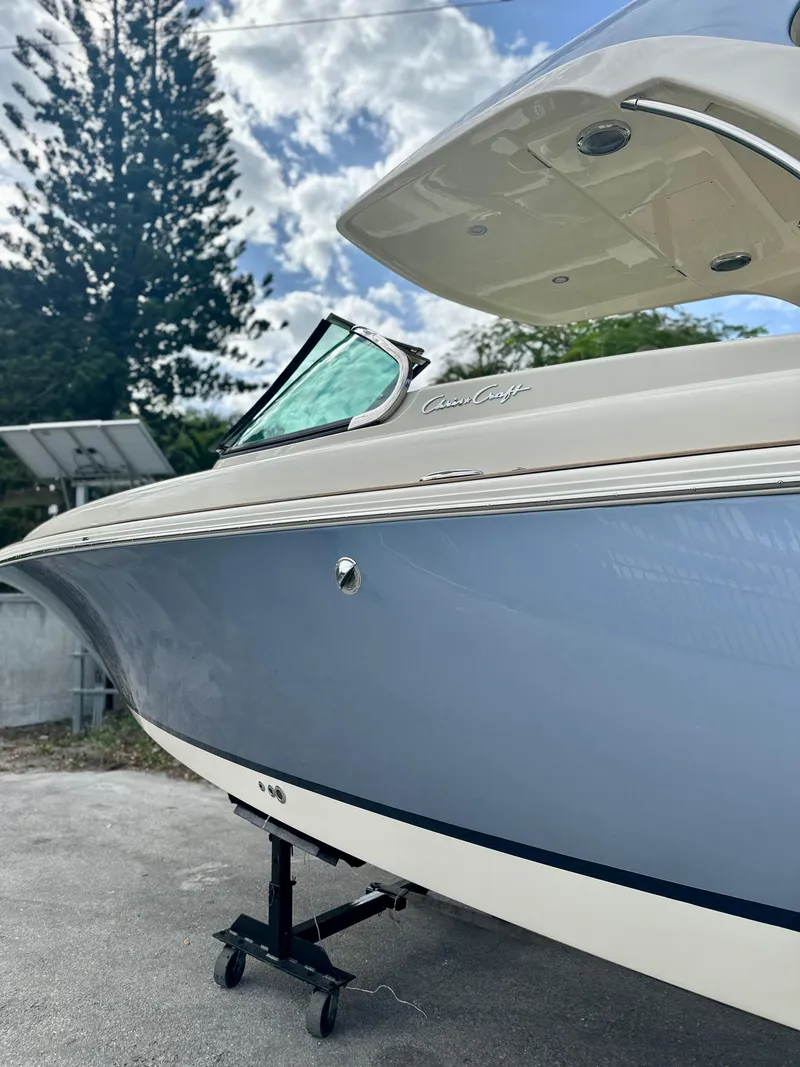 Slide: The Image of 2025 Chris-Craft Launch GT 31 boat, sleek design, blue hull, parked outdoors. - 2