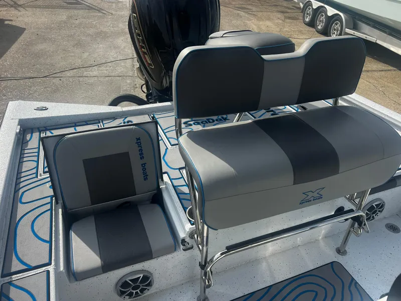 Slide: The Image of 2023 Xpress X23B Lounge boat seats with gray upholstery and stylish design. - 13