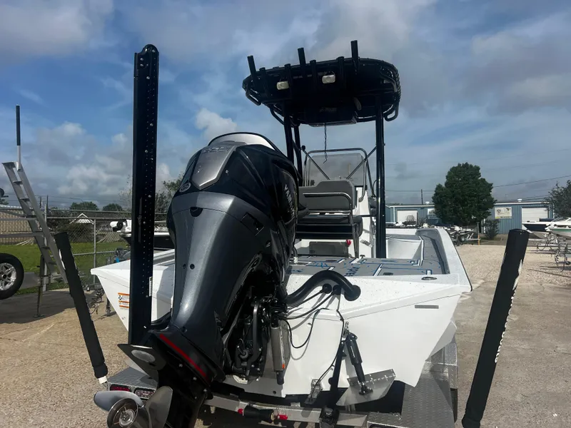 Slide: The Image of 2023 Xpress X23B Lounge boat with powerful outboard motor, parked outdoors. - 4