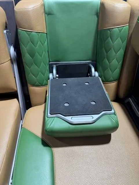 Slide: The Image of 2022 Malibu M240 interior with green and tan leather seats, featuring a foldable armrest. - 12