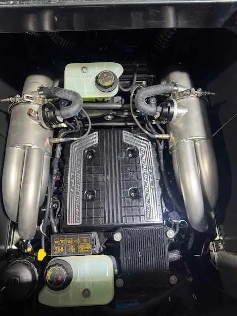 Slide: The Image of 2022 Malibu M240 engine with dual exhausts and cooling system components. - 13