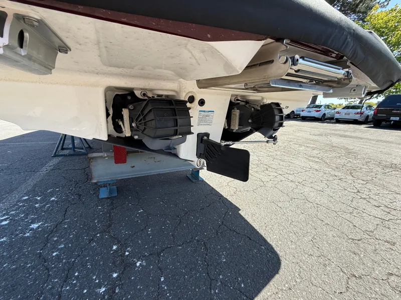 Slide: The Image of 2022 Yamaha Boats 252SD jet propulsion system, parked on asphalt, rear view. - 3