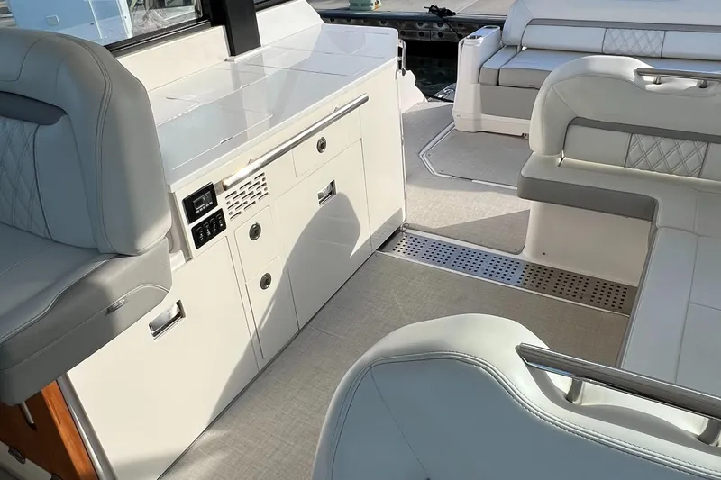 Slide: The Image of Interior of 2021 Regal 36 Grande Coupe, featuring sleek seating and modern cabinetry. - 18