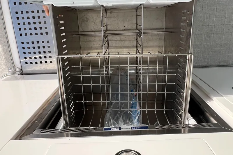 Slide: The Image of Open storage compartment on 2021 Regal 36 Grande Coupe boat. - 21