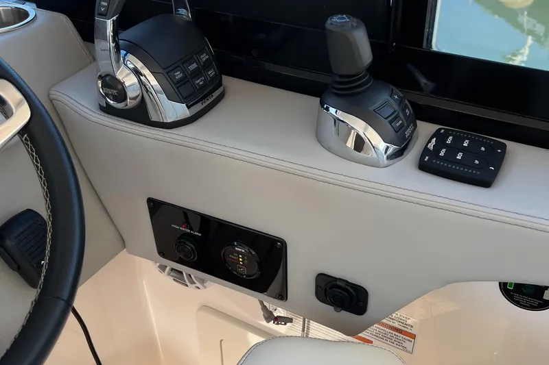 Slide: The Image of Control panel of 2021 Regal 36 Grande Coupe boat with joystick and throttle controls. - 25