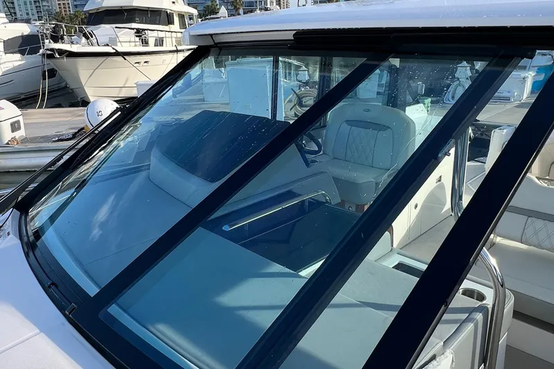 Slide: The Image of 2021 Regal 36 Grande Coupe yacht with sleek windshield and luxurious interior. - 38