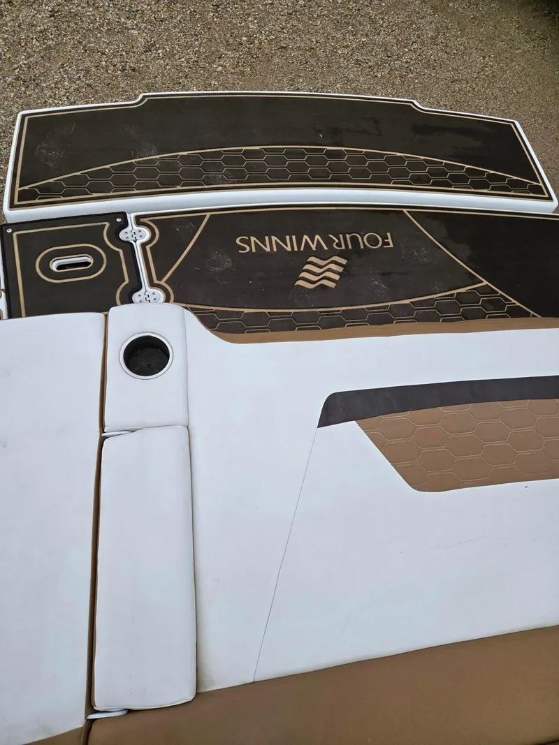 Slide: The Image of 2022 Four Winns HD2 I/O boat deck with logo and textured design. - 12