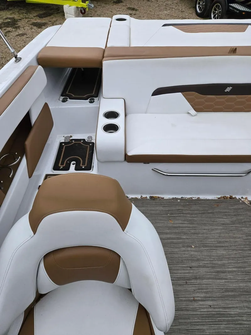 Slide: The Image of 2022 Four Winns HD2 I/O boat interior with white and brown seating. - 9
