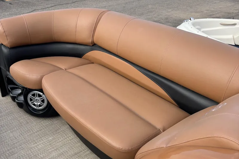 Slide: The Image of 2018 Regency R220LE3 boat seating with tan and black upholstery. - 11