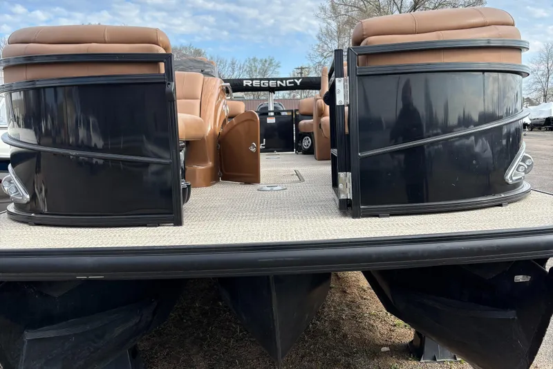 Slide: The Image of 2018 Regency R220LE3 pontoon boat with brown seating and black exterior. - 4
