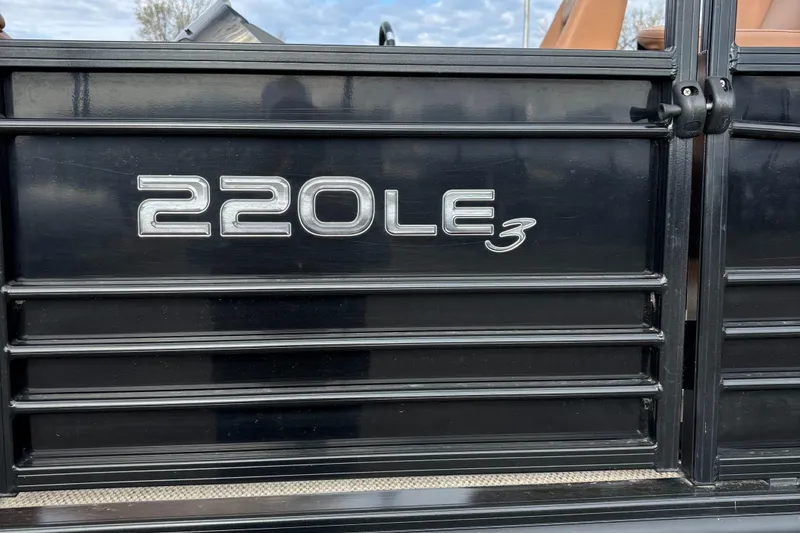 Slide: The Image of 2018 Regency R220LE3 boat model emblem on black panel. - 6