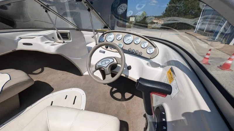 Slide: The Image of 2006 Tahoe Q4 boat interior with steering wheel and dashboard gauges. - 2
