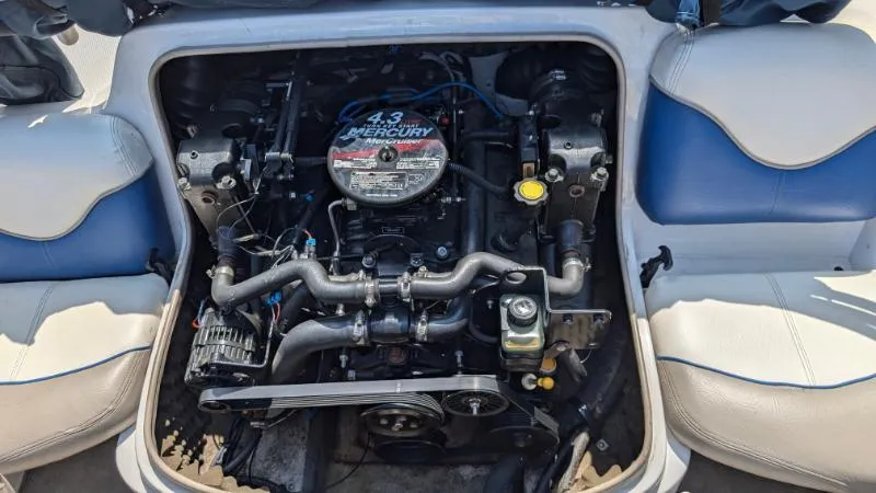 Slide: The Image of 2006 Tahoe Q4 boat engine, Mercury 4.3L, surrounded by white and blue seating. - 7