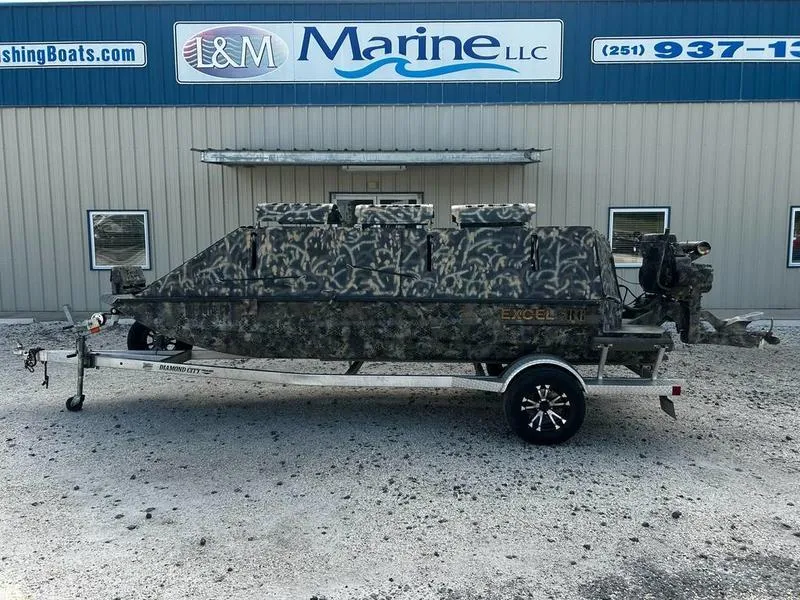 Slide: The Image of 2018 Excel F4 Pro Hull 1854 boat with camouflage design on a trailer outside L&M Marine. - 0