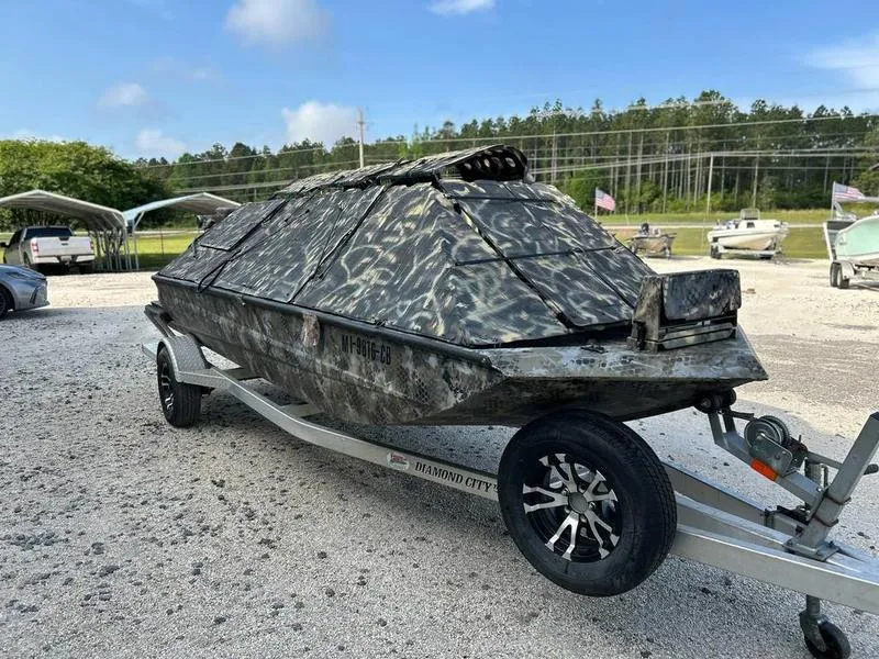 Slide: The Image of 2018 Excel F4 Pro Hull 1854 boat with camouflage design on a trailer. - 1