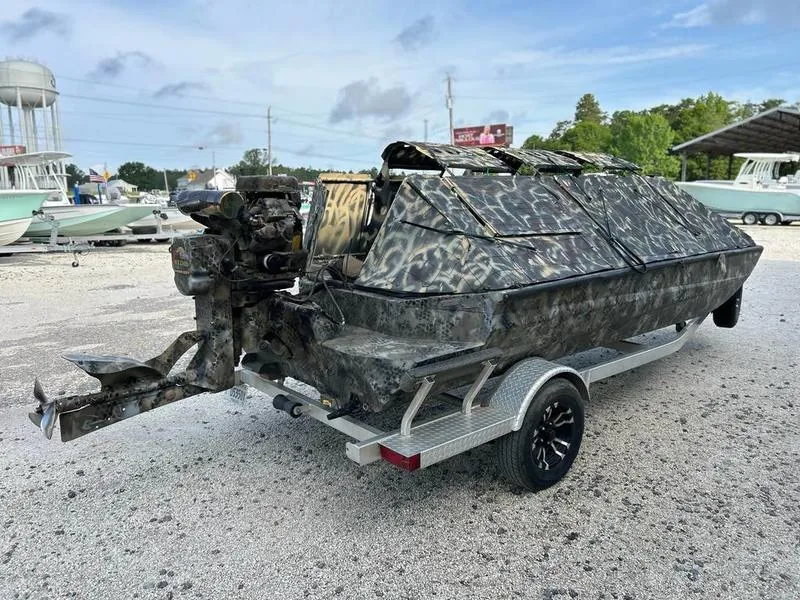 Slide: The Image of 2018 Excel F4 Pro Hull 1854 boat with camouflage design on a trailer. - 3