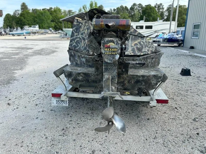 Slide: The Image of 2018 Excel F4 Pro Hull 1854 boat on trailer, camo design, parked outdoors. - 5