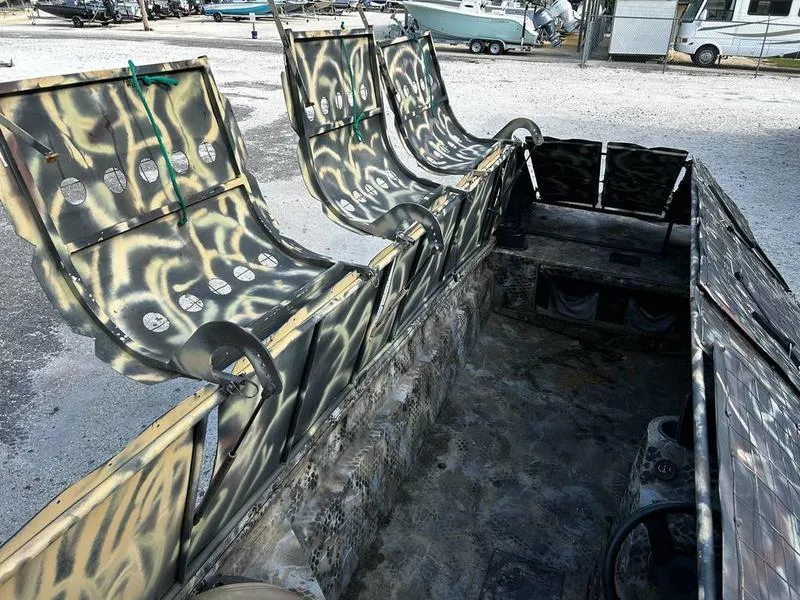 Slide: The Image of 2018 Excel F4 Pro Hull 1854 boat interior with camouflage seats and rugged design. - 6