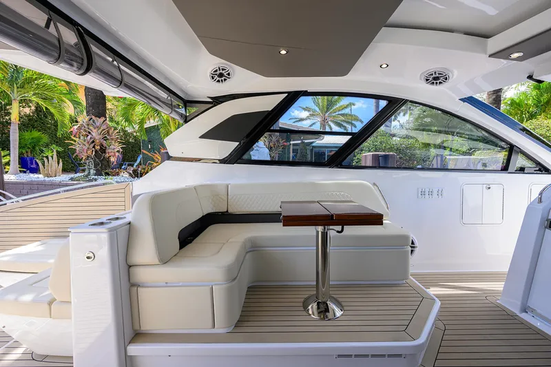 Slide: The Image of 2024 Cruisers Yachts GLS-OB interior with elegant seating and table, featuring modern design elements. - 15