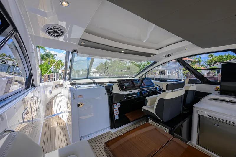 Slide: The Image of 2024 Cruisers Yachts GLS-OB interior with modern helm and luxurious seating. - 17