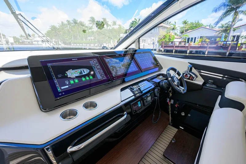 Slide: The Image of 2024 Cruisers Yachts GLS-OB helm with advanced navigation displays and luxurious interior. - 19