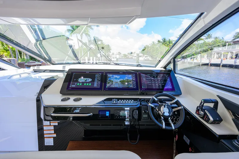 Slide: The Image of 2024 Cruisers Yachts GLS-OB helm with advanced navigation displays and luxurious interior. - 20
