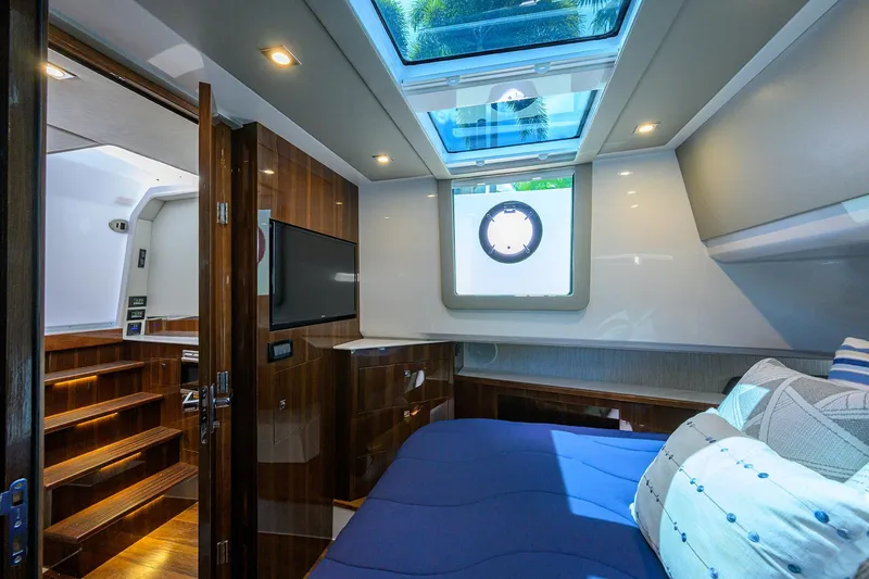Slide: The Image of Luxurious 2024 Cruisers Yachts GLS-OB cabin with skylight, modern decor, and comfortable bedding. - 25