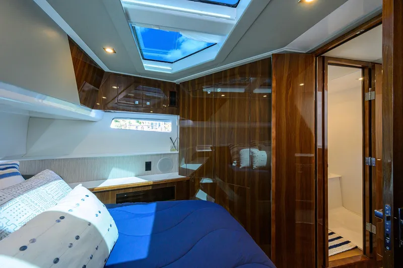 Slide: The Image of Luxurious 2024 Cruisers Yachts GLS-OB cabin with skylights and elegant wood finishes. - 26