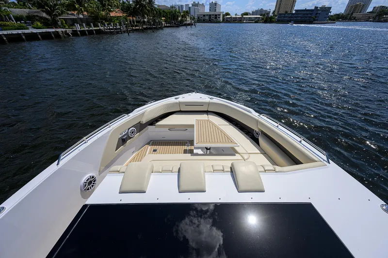 Slide: The Image of 2024 Cruisers Yachts GLS-OB bow view on calm water, showcasing luxurious seating and sleek design. - 3