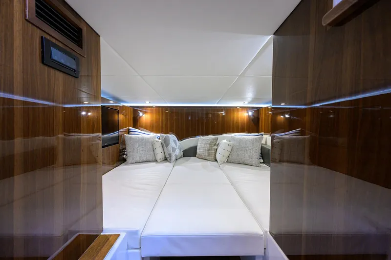 Slide: The Image of Luxurious cabin interior of 2024 Cruisers Yachts GLS-OB with elegant wood paneling. - 33