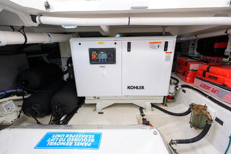 Slide: The Image of 2024 Cruisers Yachts GLS-OB engine room with Kohler generator and safety equipment. - 38