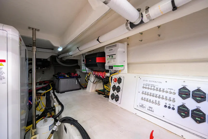 Slide: The Image of 2024 Cruisers Yachts GLS-OB engine room with electrical panels and wiring. - 40